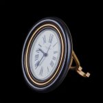 Cartier oval gilt-bronze desk clock with sapphire cabochons