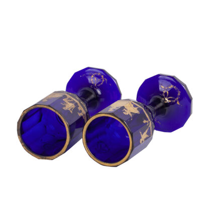 A pair of 19th century cobalt blue glass goblets gilded with children playing and lovers