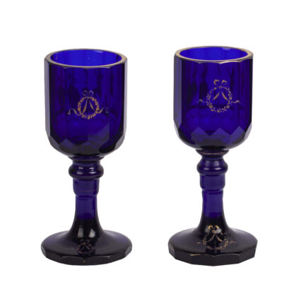 A pair of 19th century cobalt blue glass goblets gilded with children playing and lovers