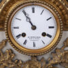 A nice detailed with hunting scene Antique Mantel clock with double patina and marble. Enamel dial and mechanism signed R. Bouvier Bruxelles.