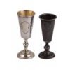 A pair of small, elegant silver shot glasses