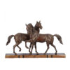 An Art Deco sculpture featuring patinated spelter horses on a stunning marble base.