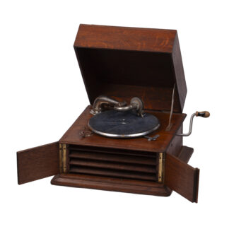 antique oak-cased tabletop gramophone with crank handle and metal tonearm